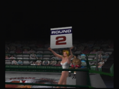 Cette charmante hôtesse annonce le 2e round (Knockout Kings 2000)