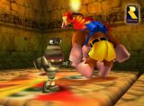 Official screenshot of the game. Kazooie is about to bite the head of this ugly mummy!